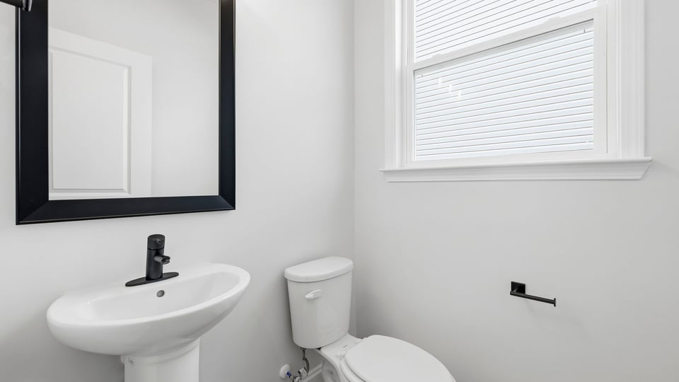 Bathroom with singe sink and window.