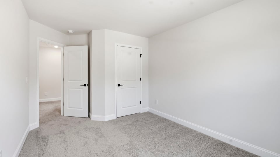 Bedroom with carpet and window.