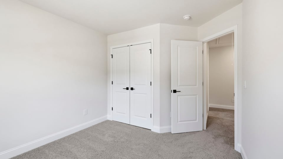 Bedroom with carpet and window.