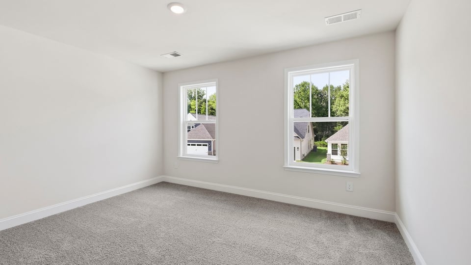 Bedroom with carpet and window.