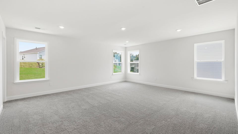Bedroom with carpet and window.
