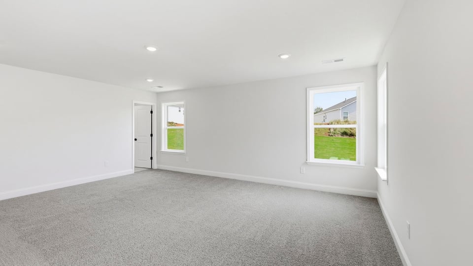Bedroom with carpet and window.