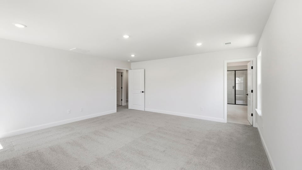 Bedroom with carpet and window.