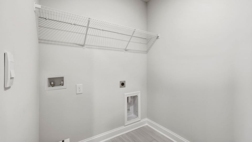 Laundry room with hanging storage racks.