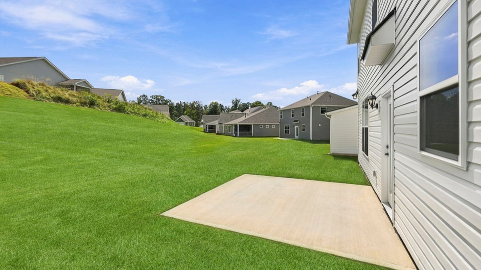 Back exterior of home with patio.