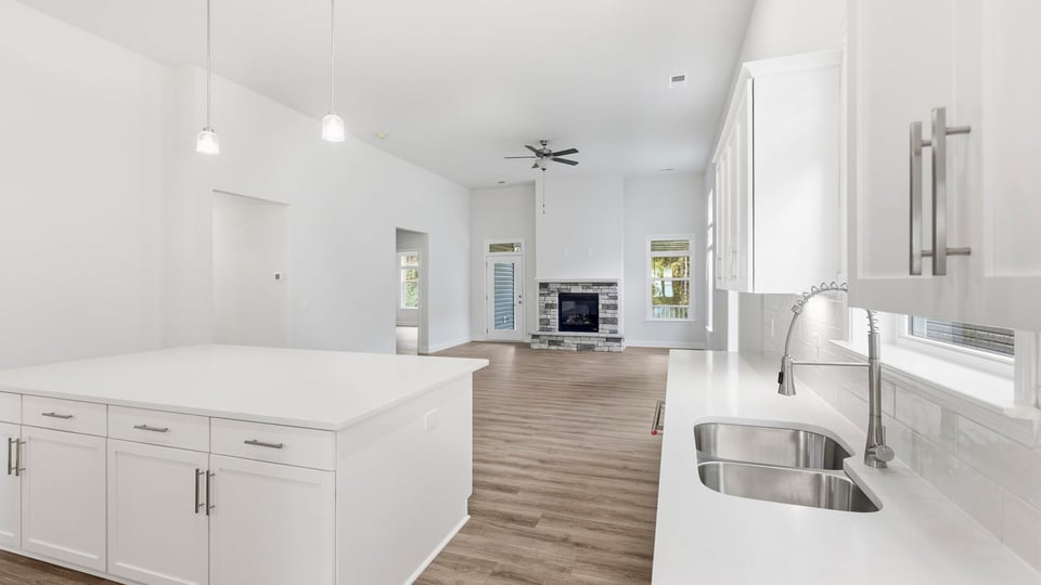 Kitchen and island with quartz countertops.