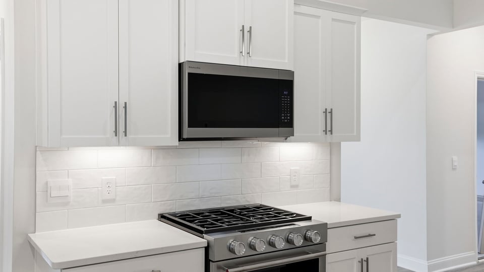 Kitchen and island with quartz countertops.