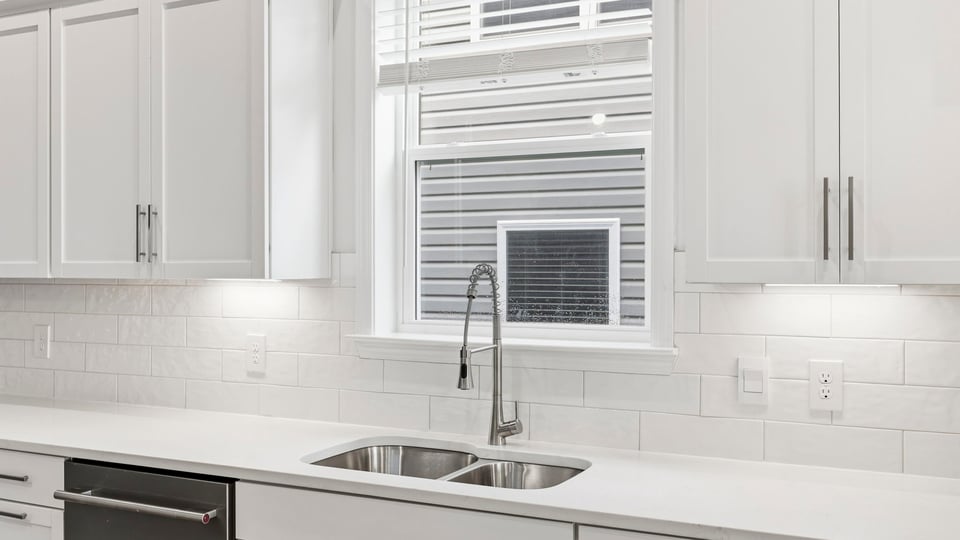 Kitchen and island with quartz countertops.