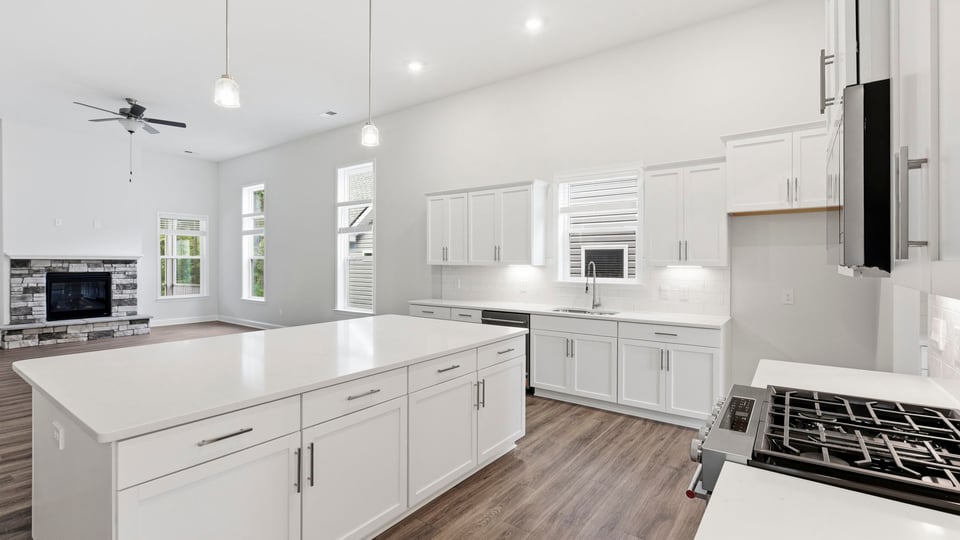 Kitchen and island with quartz countertops.