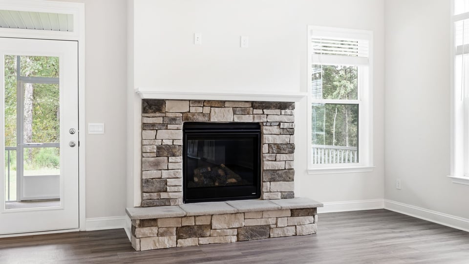 Living room with windows and fireplace.