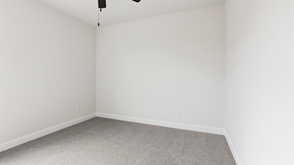 Bedroom with carpet and window.