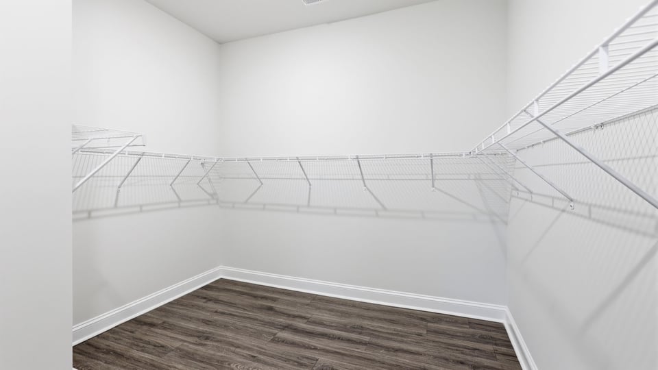 Closet with hanging storage rakcs.