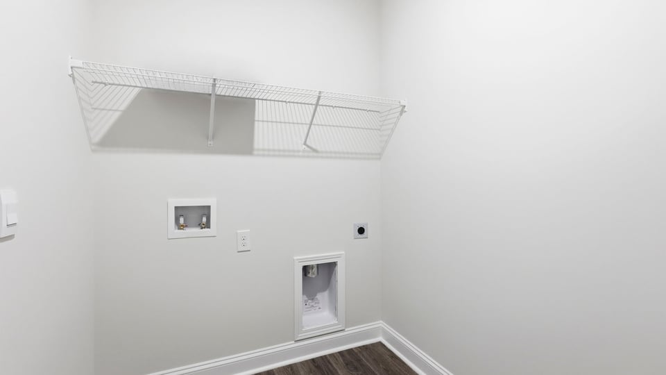 Laundry room with hanging storage racks.