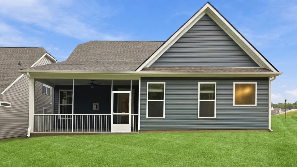 Back exterior of home with large backyard.
