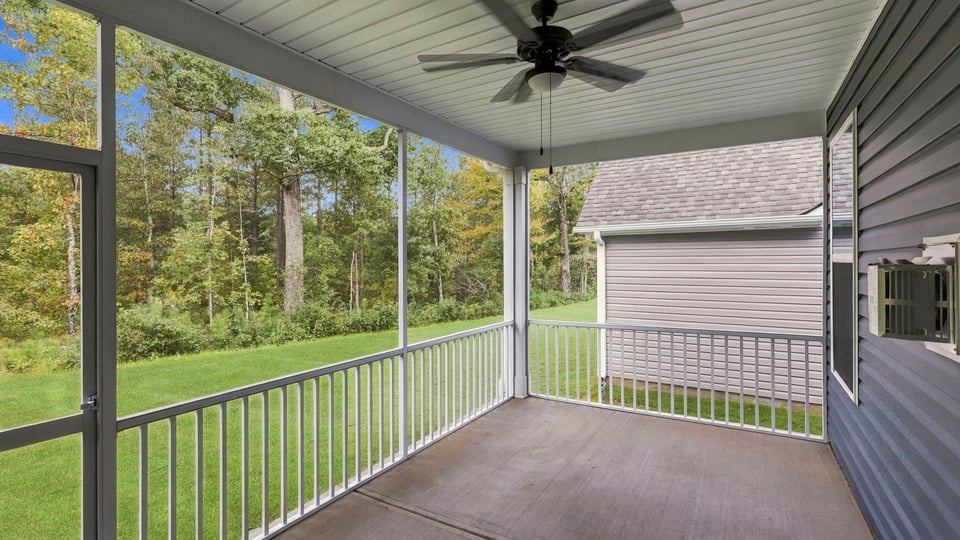 Back exterior of home with screened in patio.