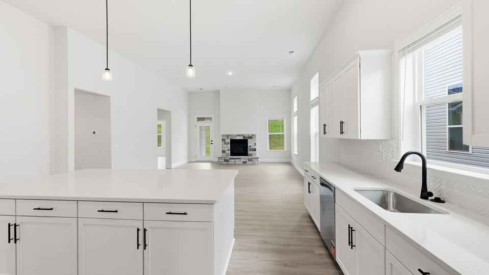 Kitchen and island with quartz countertops.