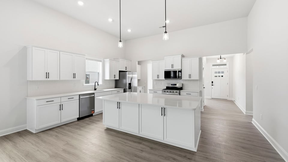 Kitchen and island with quartz countertops.