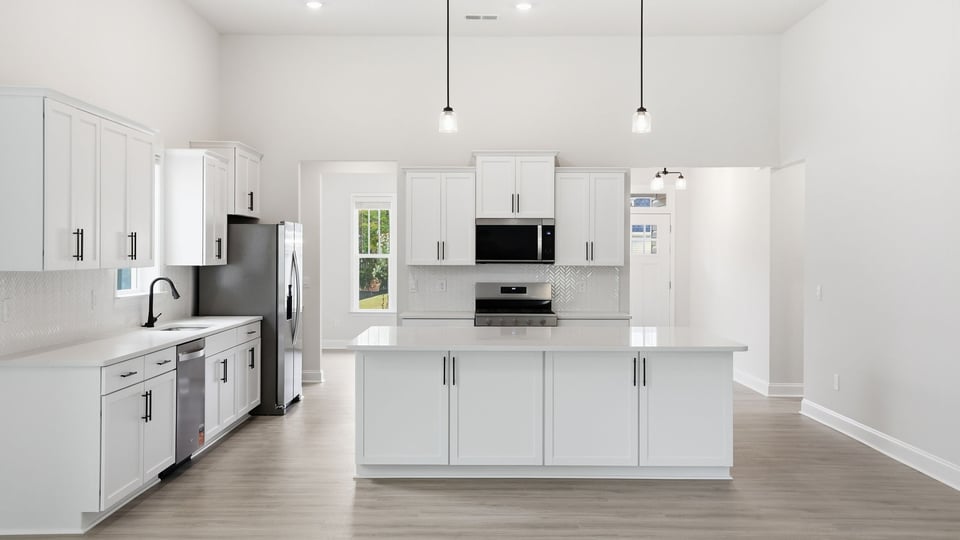 Kitchen and island with quartz countertops.