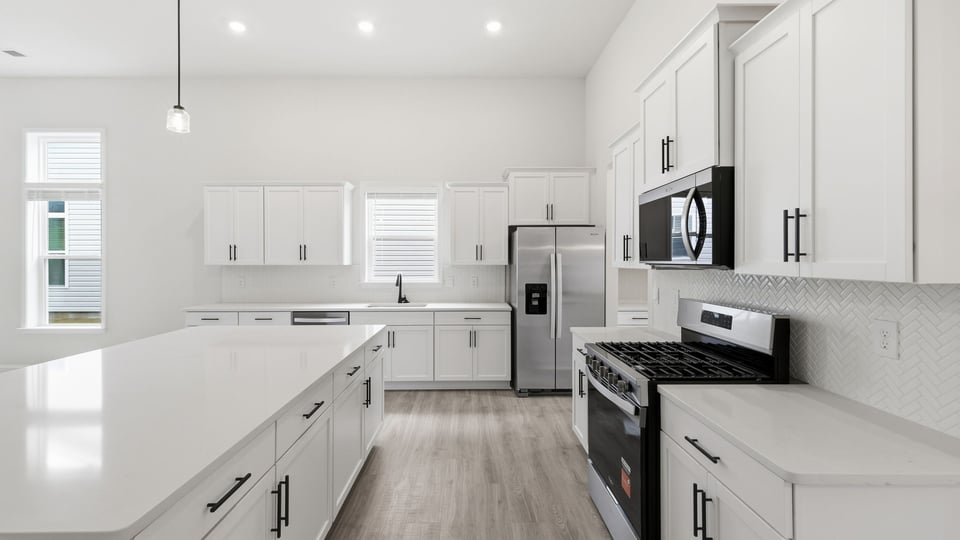 Kitchen and island with quartz countertops.