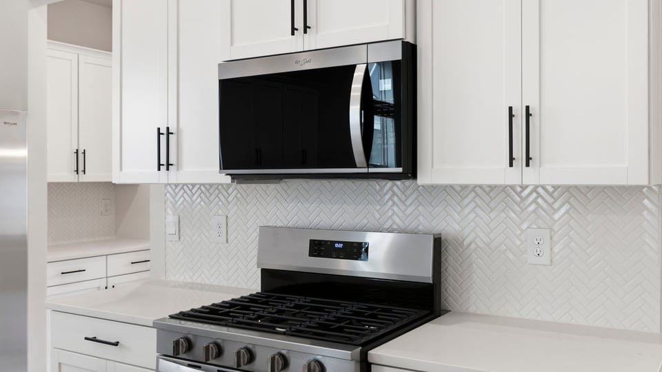 Kitchen and island with quartz countertops.