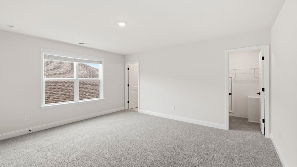 Bedroom with carpet and window.