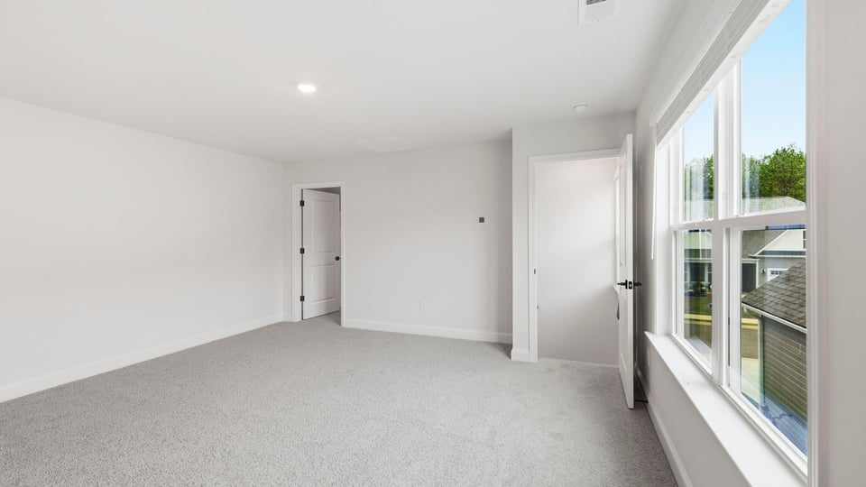 Bedroom with carpet and window.