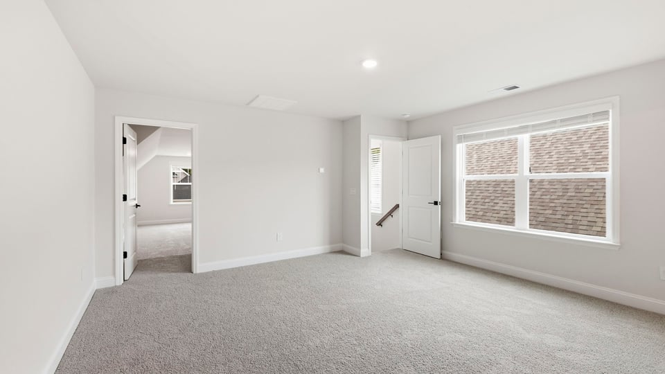 Bedroom with carpet and window.