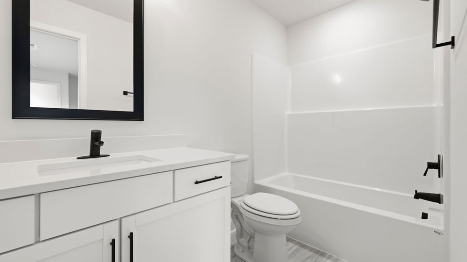 Bathroom with single vanity sink and bathtub.