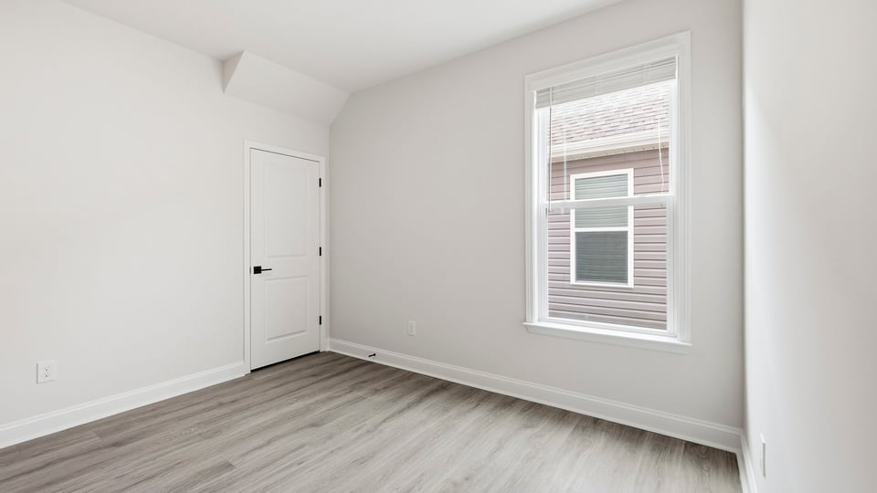 Bedroom with carpet and window.