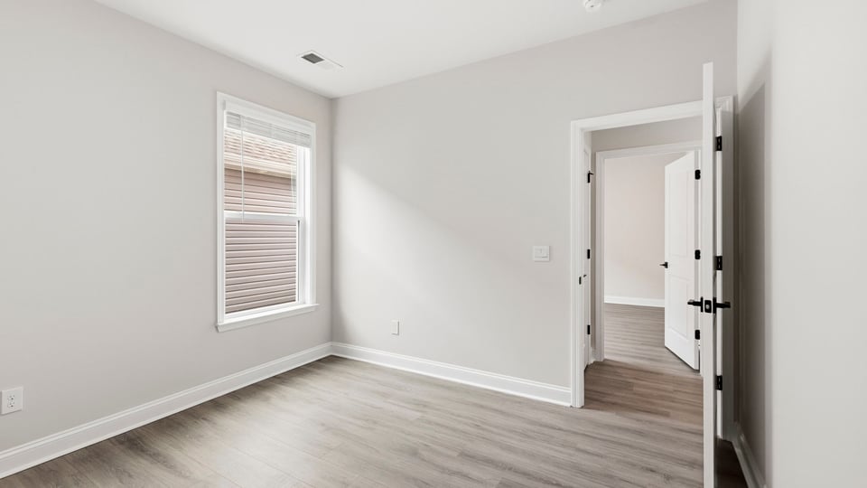 Bedroom with carpet and window.