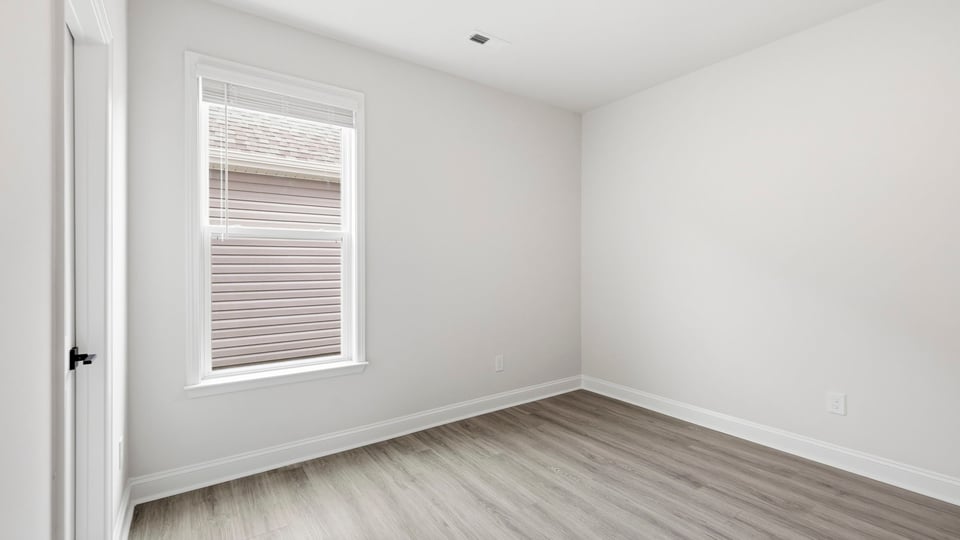 Bedroom with carpet and window.