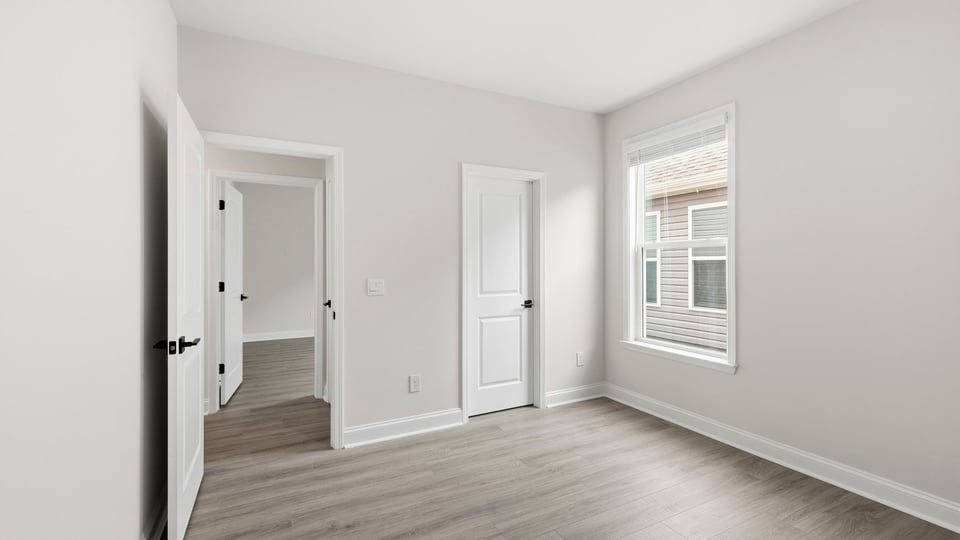 Bedroom with carpet and window.