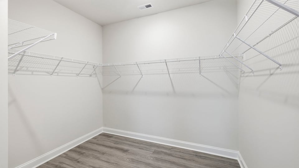 Closet with hanging storage racks.