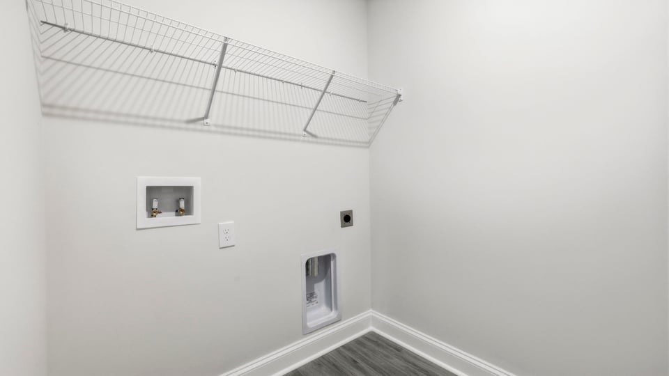Laundry room with hanging storage racks.