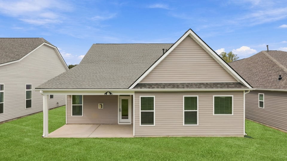 Back exterior of home with large backyard.