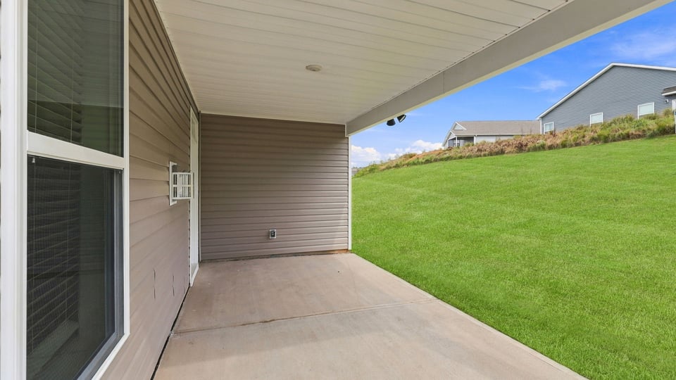 Back exterior of ohme with covered patio.