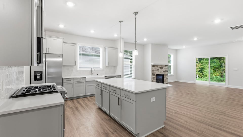 Kitchen and island with stainless steel appliances.