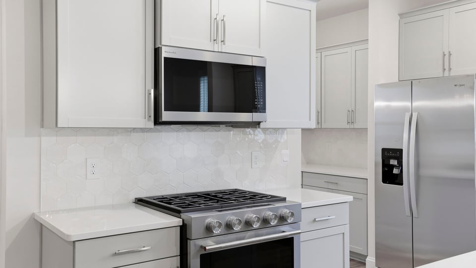 Kitchen and island with quartz countertops.