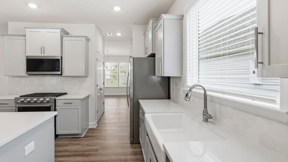 Kitchen and island with quartz countertops.