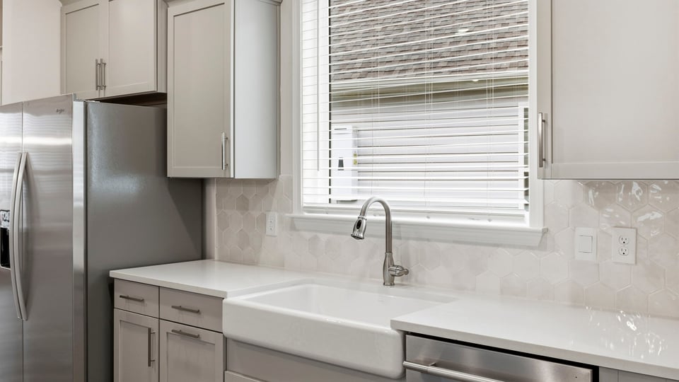 Kitchen and island with quartz countertops.