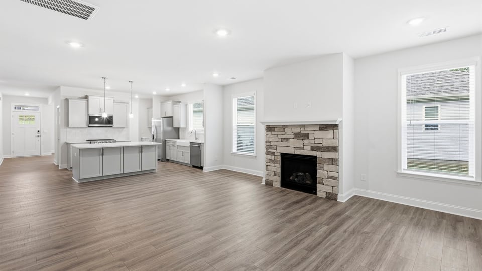 Living room with windows and fireplace.