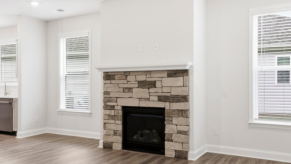 Living room with windows and fireplace.