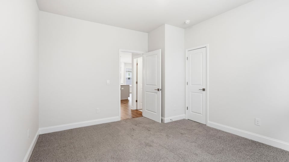 Bedroom with carpet and window.