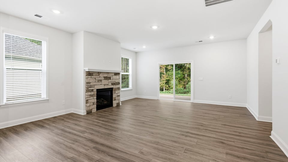 Living room with windows and fireplace.