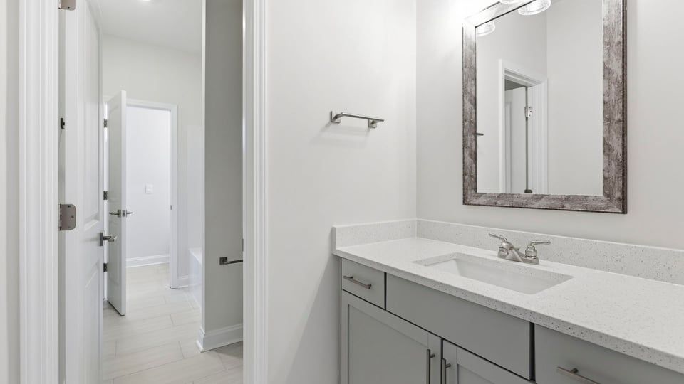 Bathroom with double vanity sink and walk in closet.
