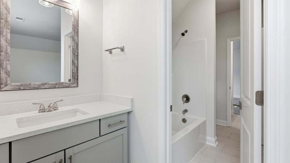 Bathroom with double vanity sink and walk in closet.