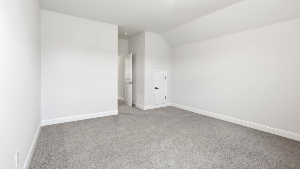 Bedroom with carpet and window.