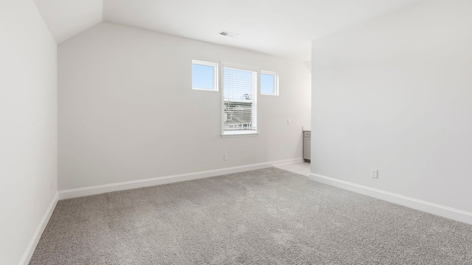 Bedroom with carpet and window.