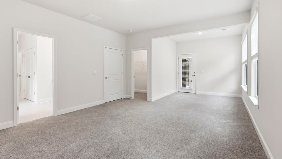 Bedroom with carpet and window.