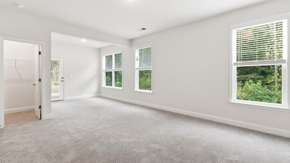 Bedroom with carpet and window.